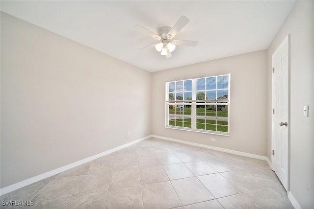 empty room with light tile patterned floors and ceiling fan