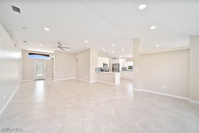 unfurnished living room featuring light tile patterned flooring and ceiling fan