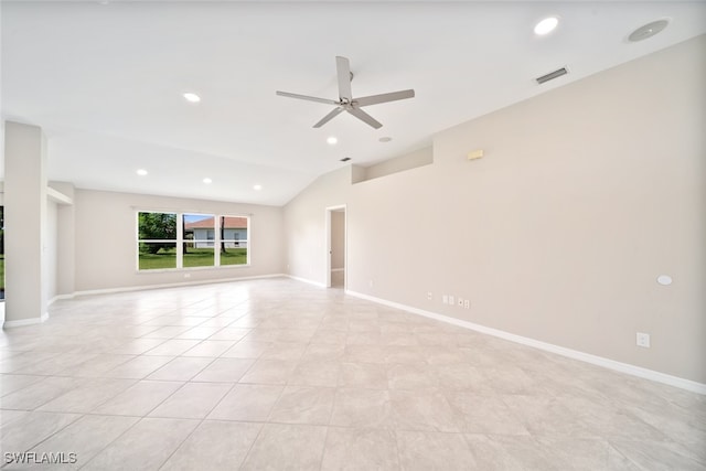 interior space featuring ceiling fan, vaulted ceiling, and light tile patterned floors