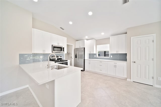 kitchen featuring light tile patterned flooring, stainless steel appliances, white cabinetry, and decorative backsplash