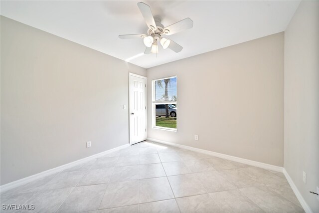 spare room featuring light tile patterned flooring and ceiling fan