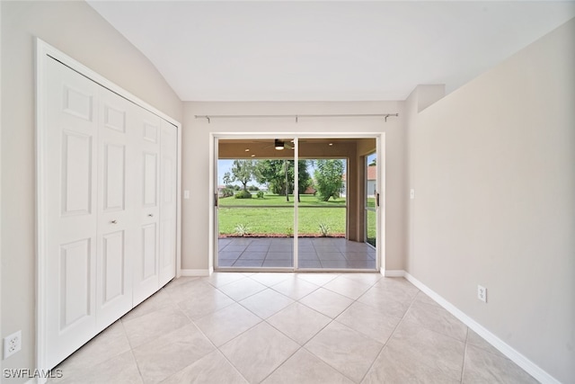 unfurnished bedroom featuring light tile patterned flooring, access to exterior, and a closet