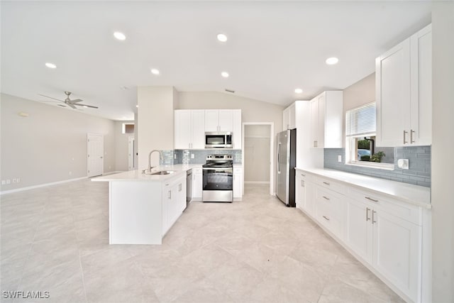 kitchen with kitchen peninsula, light tile patterned floors, stainless steel appliances, and sink