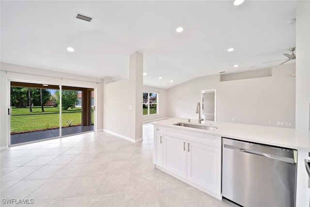 kitchen with light tile patterned flooring, stainless steel dishwasher, white cabinetry, ceiling fan, and sink