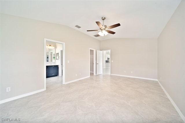 unfurnished bedroom with ceiling fan, connected bathroom, light tile patterned floors, and lofted ceiling