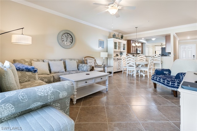 living room with crown molding, ceiling fan, and dark tile patterned flooring