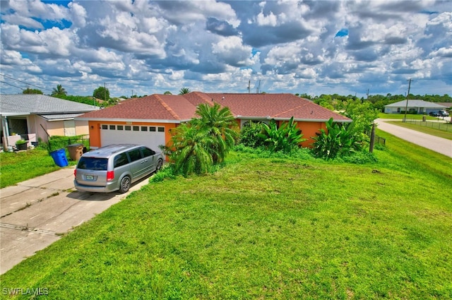 view of front of property with a garage and a front yard