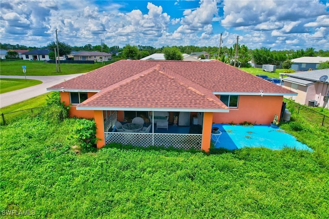 rear view of property with a lawn