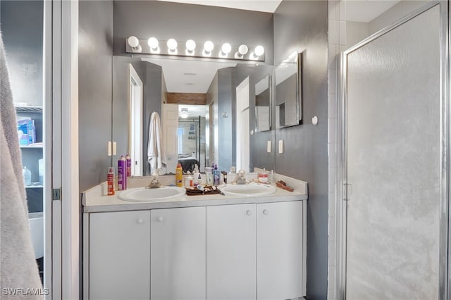 bathroom with dual vanity and walk in shower