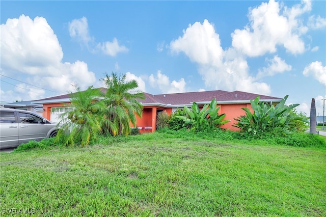 obstructed view of property with a front lawn