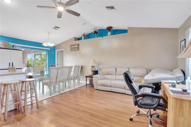 office space featuring lofted ceiling, ceiling fan with notable chandelier, and light hardwood / wood-style flooring