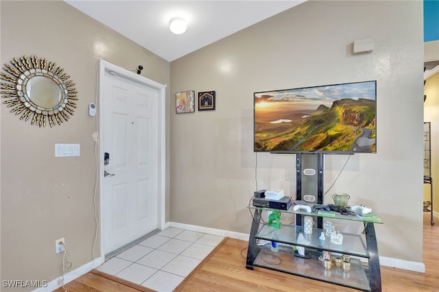 foyer entrance featuring light hardwood / wood-style floors and lofted ceiling