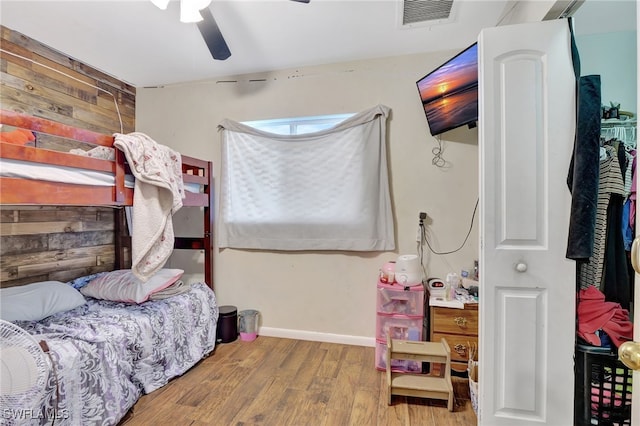 bedroom with light hardwood / wood-style flooring and ceiling fan