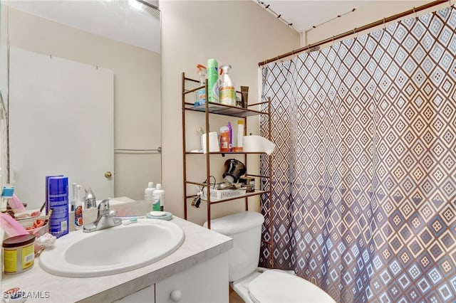 bathroom featuring vanity and toilet