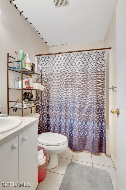 bathroom featuring vanity, tile patterned flooring, and toilet