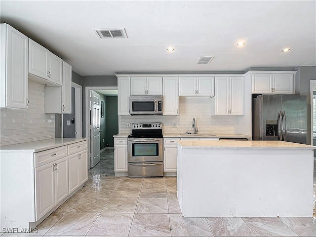 kitchen featuring appliances with stainless steel finishes and white cabinetry