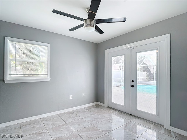 entryway featuring ceiling fan and french doors