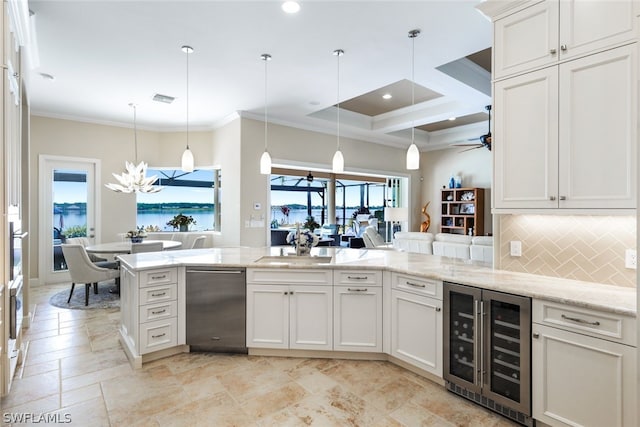 kitchen featuring crown molding, pendant lighting, a water view, and beverage cooler