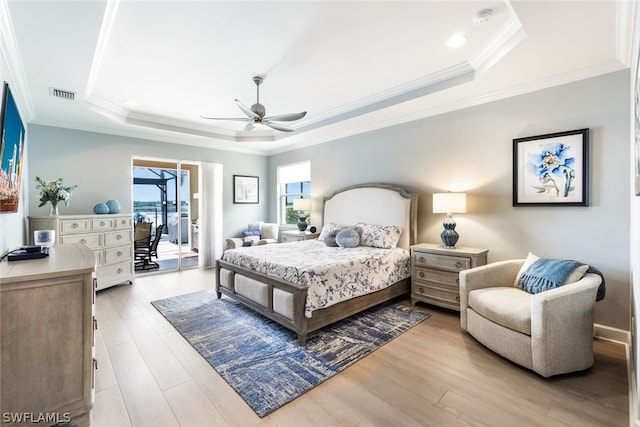 bedroom featuring ceiling fan, a raised ceiling, crown molding, and access to outside