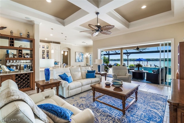 living room with beam ceiling, a water view, ornamental molding, and coffered ceiling