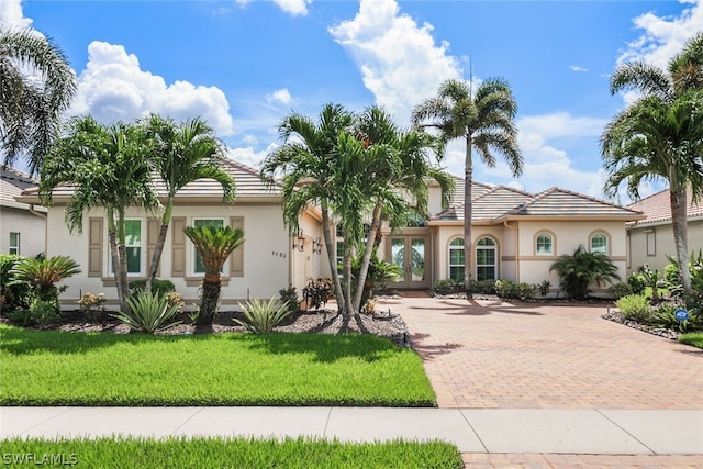 mediterranean / spanish house featuring a front yard