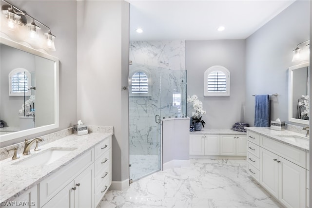 bathroom with vanity and a shower with door