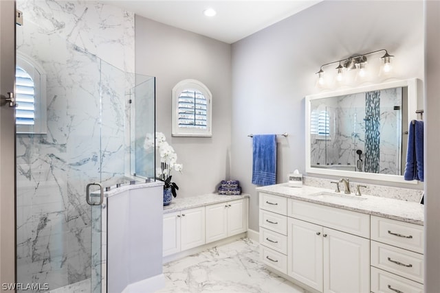 bathroom featuring vanity and a shower with door