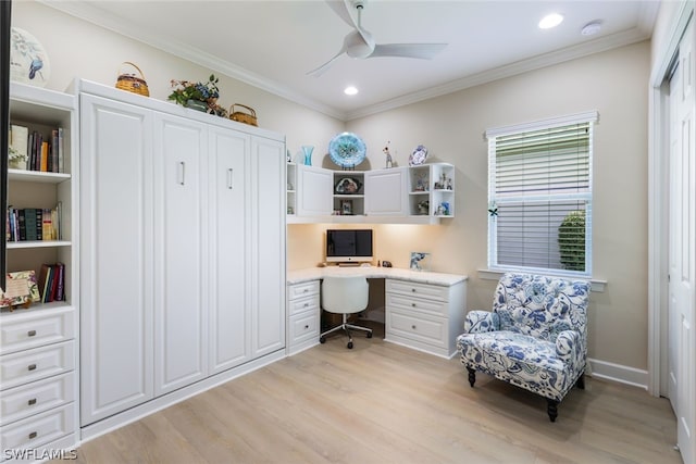 office featuring built in desk, light wood-type flooring, ceiling fan, and crown molding