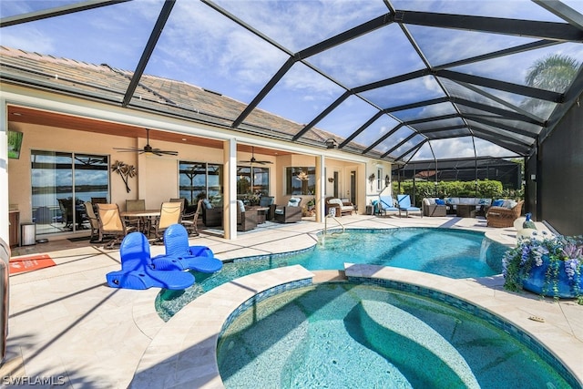 view of swimming pool featuring ceiling fan, a lanai, an outdoor hangout area, a patio area, and an in ground hot tub