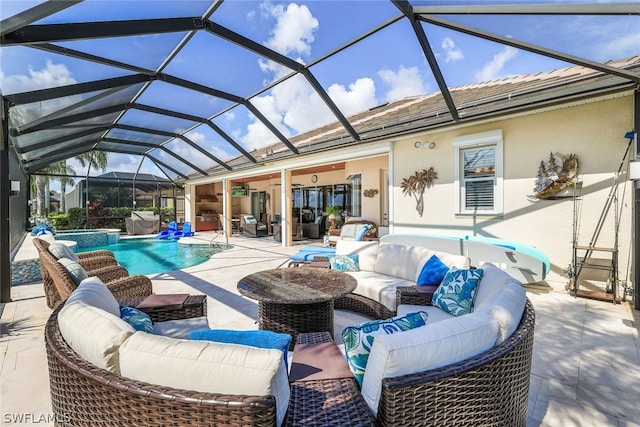 view of patio with outdoor lounge area, ceiling fan, and glass enclosure