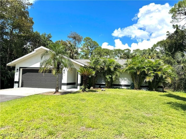 single story home with a garage and a front lawn