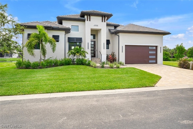 27132 Serrano Way, Bonita Springs, FL 34135 - prairie-style house featuring a front yard, driveway, and a tiled roof