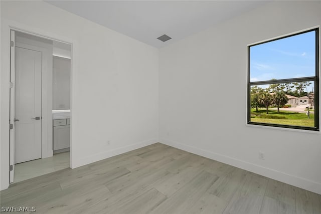 spare room featuring light wood-type flooring