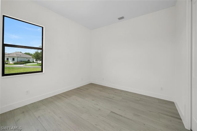 spare room featuring light hardwood / wood-style floors