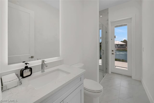 bathroom featuring walk in shower, a water view, vanity, and toilet