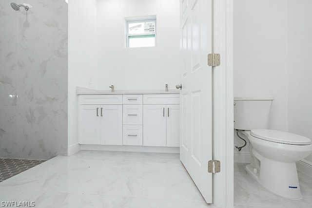 bathroom featuring tile patterned flooring, toilet, and tiled shower