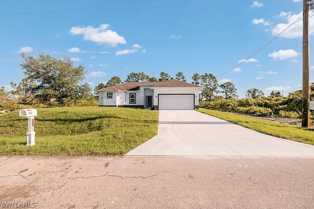 view of front of home featuring a garage and a front lawn