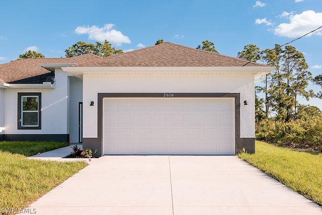 view of front of home featuring a garage and a front lawn