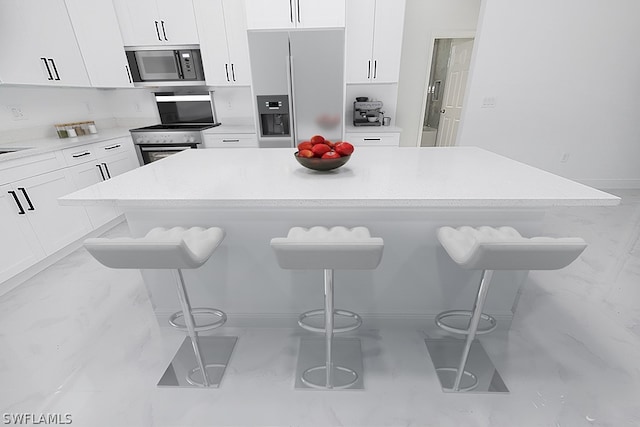 kitchen featuring a kitchen breakfast bar, appliances with stainless steel finishes, and a kitchen island