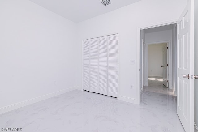 unfurnished bedroom with a closet and tile patterned flooring