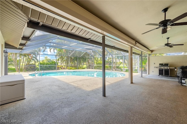 view of pool with a patio, glass enclosure, a grill, and ceiling fan