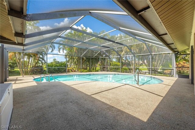 view of pool featuring a patio area and glass enclosure