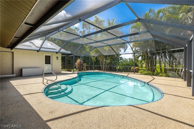 view of pool with a patio area and a lanai