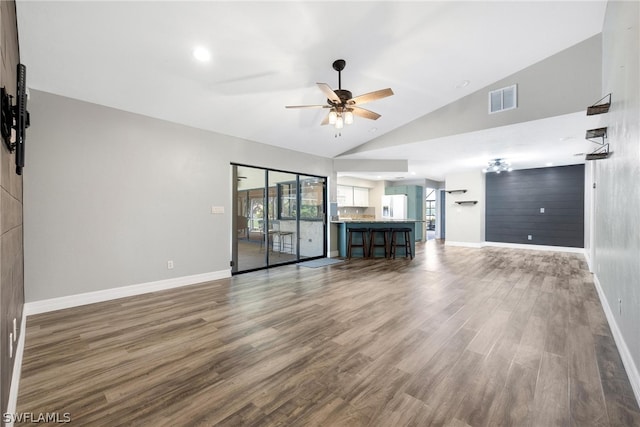 unfurnished living room with wood-type flooring, high vaulted ceiling, and ceiling fan