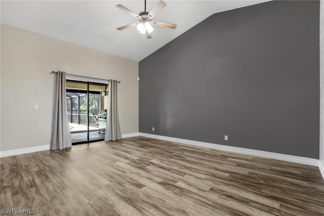 empty room featuring wood-type flooring, high vaulted ceiling, and ceiling fan