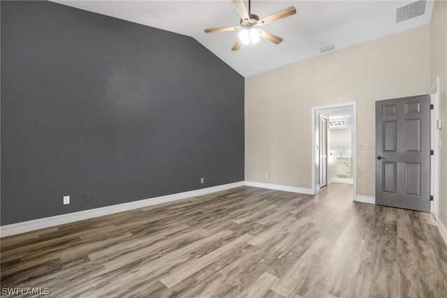 unfurnished room with lofted ceiling, hardwood / wood-style floors, and ceiling fan