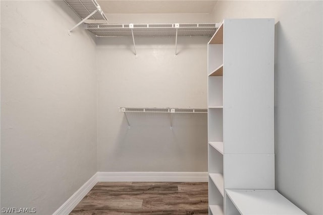 spacious closet featuring hardwood / wood-style flooring