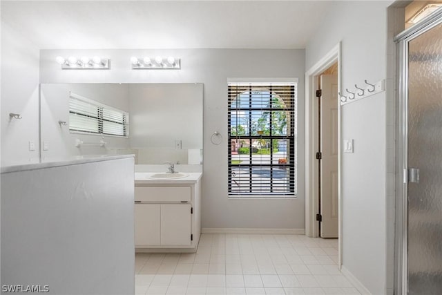 bathroom with vanity, tile patterned floors, and a shower with door