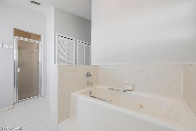 bathroom with plus walk in shower and tile patterned flooring