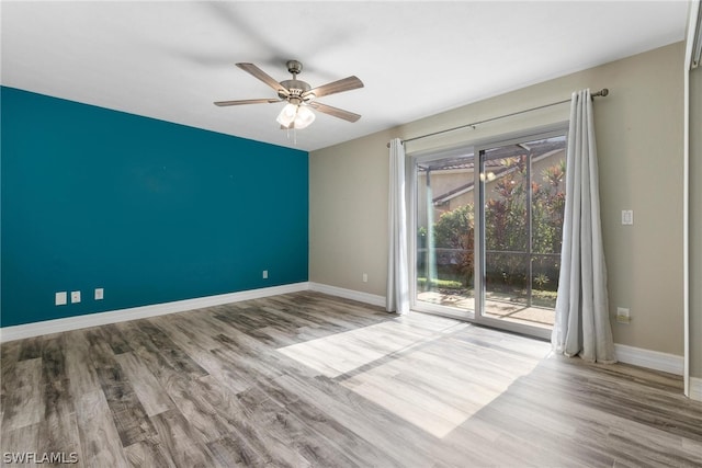 spare room with ceiling fan and light hardwood / wood-style floors